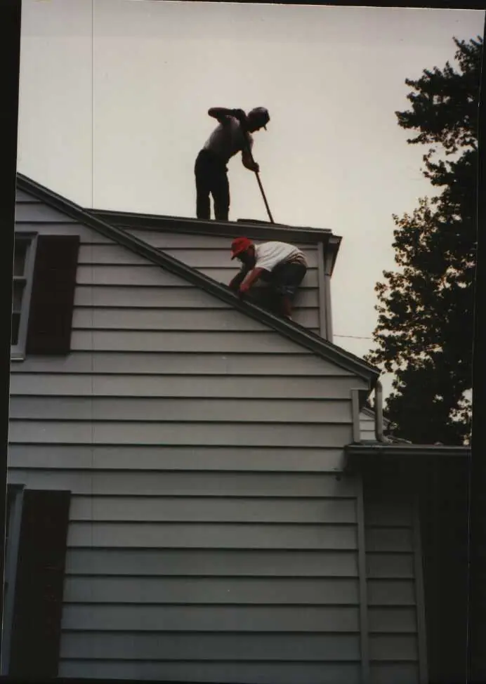Derik Kilker on a roof with his grandfather, 1995