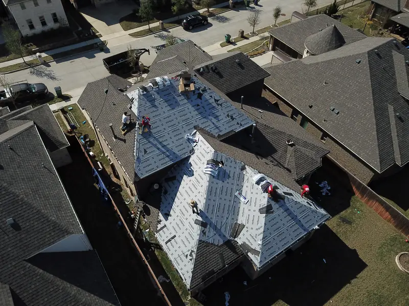 Kilker crew installing underlayment on a McKinney home
